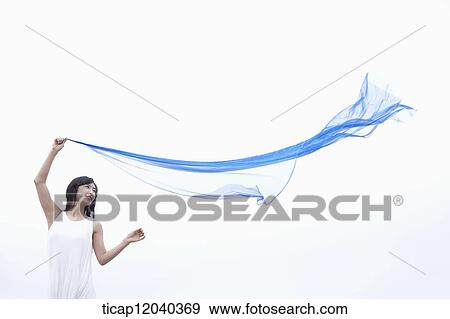 A woman holding a thin sheet View Large Photo Image Stock Photo - A woman holding a thin sheet . Fotosearch