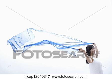 A woman holding up a thin linen in white background View Large Photo Image Stock Photo - A woman holding up a thin linen in white background. Fotosearch