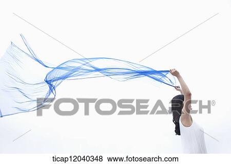 A woman holding up a thin linen in wind View Large Photo Image Stock Photo - A woman holding up a thin linen in wind. Fotosearch