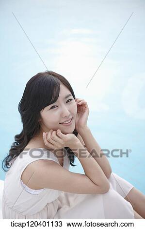 A woman in a white dress leaning in her hand next to the pool View Large Photo Image Stock Image - A woman in a white dress leaning in her hand next to the pool. Fotosearch