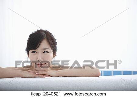 A woman leaning on a edge of bathtub in a bathtub View Large Photo Image Stock Image - A woman leaning on a edge of bathtub in a bathtub. Fotosearch