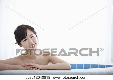 A woman leaning on a edge of bathtub in a bathtub View Large Photo Image Stock Photo - A woman leaning on a edge of bathtub in a bathtub. Fotosearch