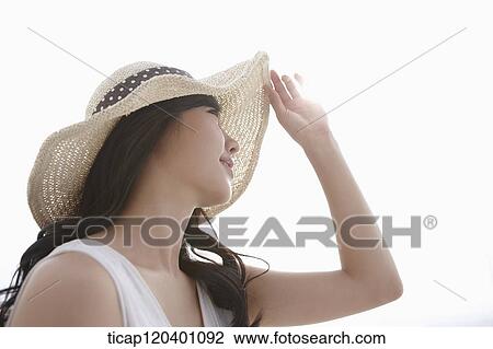 A woman wearing a white dress and straw hat posing in white background View Large Photo Image Stock Image - A woman wearing a white dress and straw hat posing in white background. Fotosearch