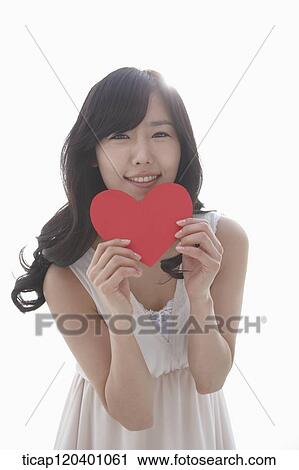 A woman with white dress and wavy hair holding a shape of heart View Large Photo Image Stock Image - A woman with white dress and wavy hair holding a shape of heart. Fotosearch