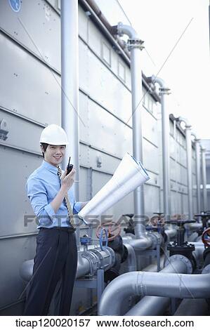 Stock Photo - An architect holding portfolio standing with radio receiver . Fotosearch