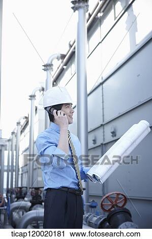An architect talking on radio in contruction site View Large Photo Image Stock Image - An architect talking on radio in contruction site. Fotosearch