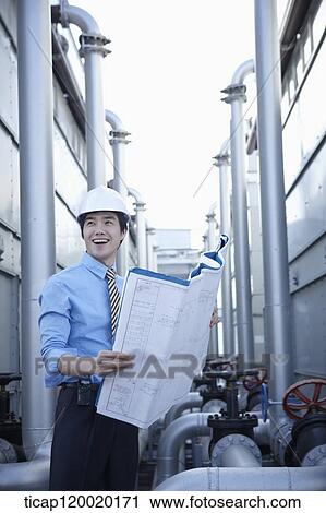 Stock Image - An architect wearing a suit laughing with portfolio in his hands. Fotosearch