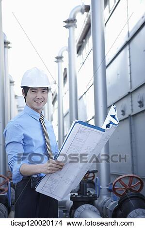 An architect wearing a suit smiling at camera View Large Photo Image Picture - An architect wearing a suit smiling at camera. Fotosearch