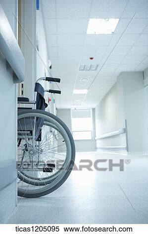Stock Photography - An empty wheelchair entering a hospital room in empty hospital. Fotosearch