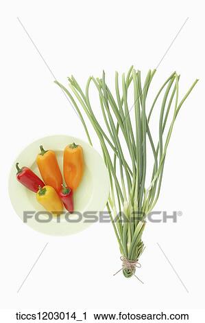 Bell peppers on a white plate next to spring onion View Large Photo Image Stock Image - Bell peppers on a white plate next to spring onion. Fotosearch