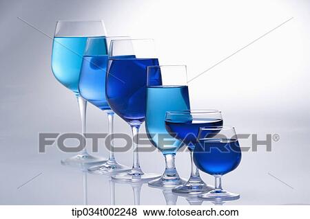 Stock Photo - blue liquid in the glasses in a row. Fotosearch