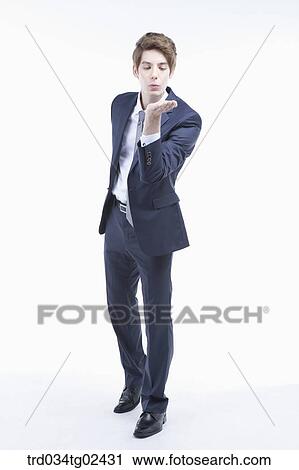 businessman blowing his hand View Large Photo Image Stock Image - businessman blowing his hand. Fotosearch