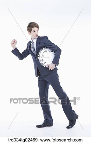 businessman carrying a clock View Large Photo Image Stock Photo - businessman carrying a clock . Fotosearch