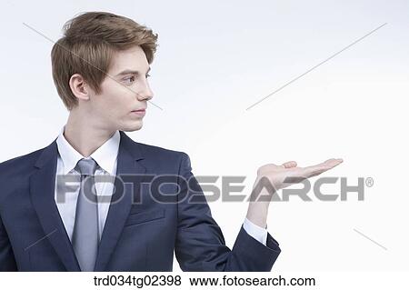 Stock Photo - businessman having his palm facing upwards. Fotosearch