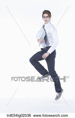 businessman jumping into the air with a folder in his hand View Large Photo Image Stock Photograph - businessman jumping into the air with a folder in his hand. Fotosearch