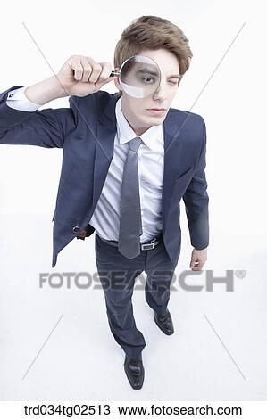 businessman looking into the reading glasses View Large Photo Image Stock Image - businessman looking into the reading glasses. Fotosearch