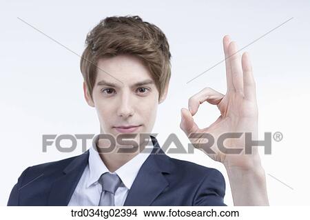 Picture - businessman making a OK sign. Fotosearch