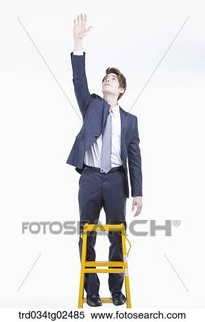 businessman reaching out his hand on the ladder View Large Photo Image Stock Photography - businessman reaching out his hand on the ladder. Fotosearch