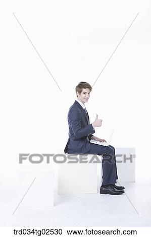 businessman sitting on the box and giving a thumbs-up View Large Photo Image Stock Image - businessman sitting on the box and giving a thumbs-up. Fotosearch