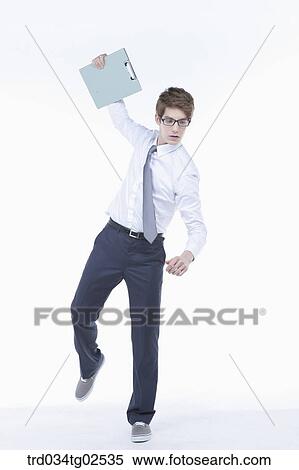 businessman standing awkwardly with a folder in his hand View Large Photo Image Stock Photography - businessman standing awkwardly with a folder in his hand. Fotosearch