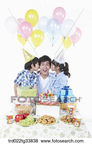 Stock Photo - family having a birthday party. Fotosearch