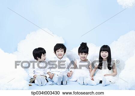 Stock Image - four kids with looks of angels on the clouds. Fotosearch