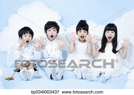 Stock Photo - four kids with looks of angels on the clouds. Fotosearch