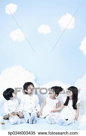 four kids with looks of angels on the clouds View Large Photo Image Stock Photography - four kids with looks of angels on the clouds. Fotosearch