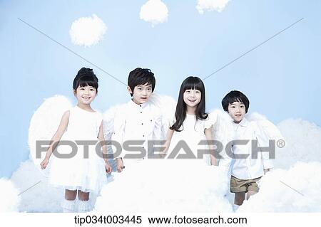Stock Photography - four kids with looks of angels on the clouds. Fotosearch