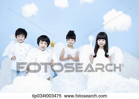 Stock Photography - four kids with looks of angels on the clouds. Fotosearch