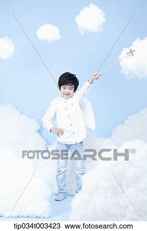 Stock Image - little boy looks of angel on the clouds. Fotosearch
