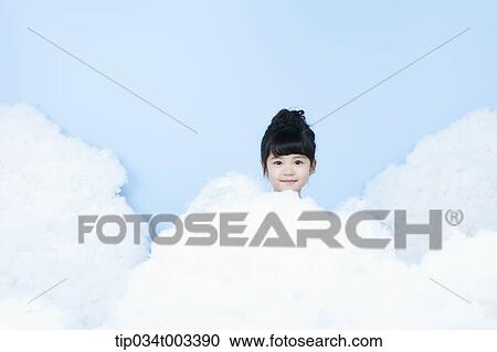 Stock Image - little girl looks of angel on the clouds. Fotosearch