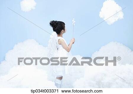 Stock Image - little girl with looks of angel on the clouds. Fotosearch