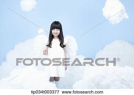 Stock Photo - little girl with looks of angel on the clouds. Fotosearch