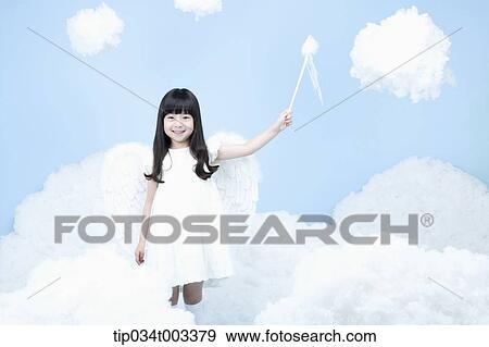 Stock Photo - little girl with looks of angel on the clouds. Fotosearch