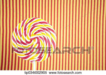 Stock Photography - lollipop in the red and yellow stripped background. Fotosearch