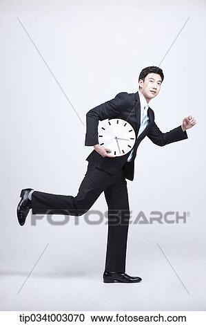 man carrying a clock and running View Large Photo Image Stock Image - man carrying a clock and running. Fotosearch