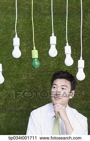 man coming up with idea under the bulbs hanging on the ceiling View Large Photo Image Stock Image - man coming up with idea under the bulbs hanging on the ceiling . Fotosearch