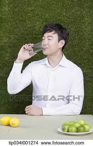 man drinking a glass of water View Large Photo Image Picture - man drinking a glass of water. Fotosearch