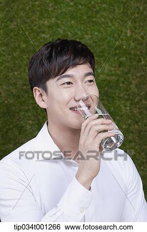 man drinking a glass of water View Large Photo Image Stock Photograph - man drinking a glass of water. Fotosearch