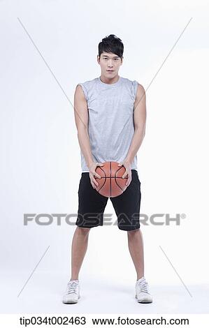 Stock Image - man holding a basketball. Fotosearch