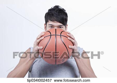 Stock Photo - man holding a basketball. Fotosearch
