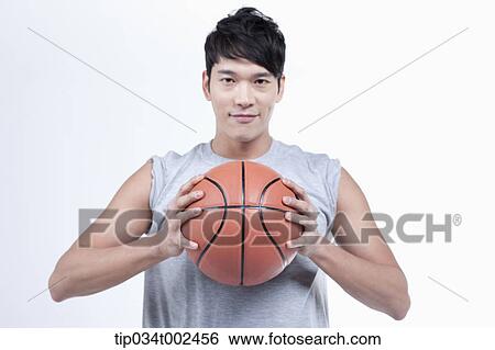 Stock Photograph - man holding a basketball. Fotosearch