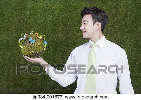 man holding a sphere covered with colorful butterflies View Large Photo Image Stock Photo - man holding a sphere covered with colorful butterflies . Fotosearch
