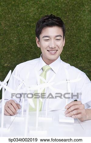 Stock Photo - man playing with pinwheels on the table. Fotosearch