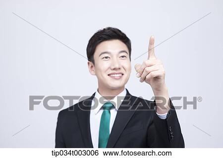 Stock Photograph - man pointing out with his index finger . Fotosearch