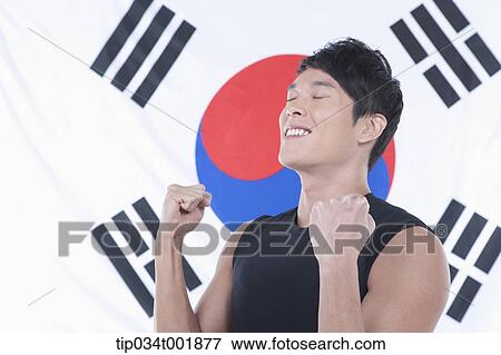 man shouting with excitement in front of the Korean national flag View Large Photo Image Stock Photo - man shouting with excitement in front of the Korean national flag. Fotosearch
