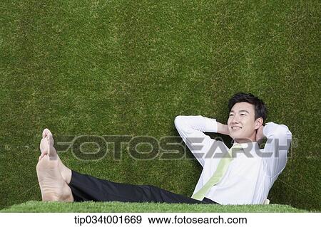 Stock Photo - man sitting and leaning against the chair . Fotosearch