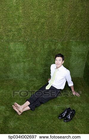 man sitting in his bare feet View Large Photo Image Stock Photo - man sitting in his bare feet. Fotosearch