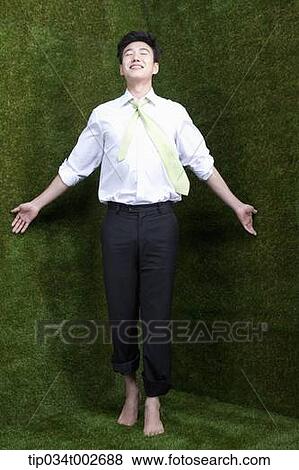 Stock Photo - man standing in the current of breeze . Fotosearch